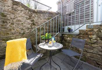 The cute courtyard at the back of the cottage catches the afternoon sun. 