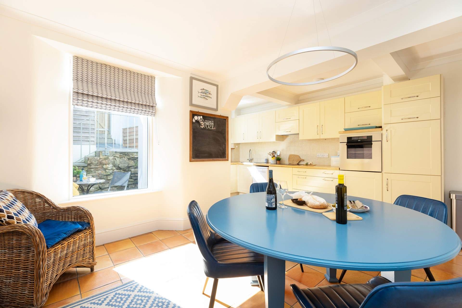 The open plan kitchen/diner catches the afternoon light. 