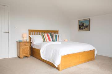 This bright master bedroom has a Juliet balcony with pretty views to the rear, overlooking the nature reserve.