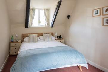 The master bedroom has a five- foot double bed, a sloping ceiling and quirky sloping floor.
