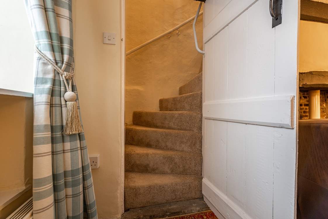 A view of the stairs with the traditional door. Should you wish to use a stair-gate, you will need to place it at the door of the twin room.