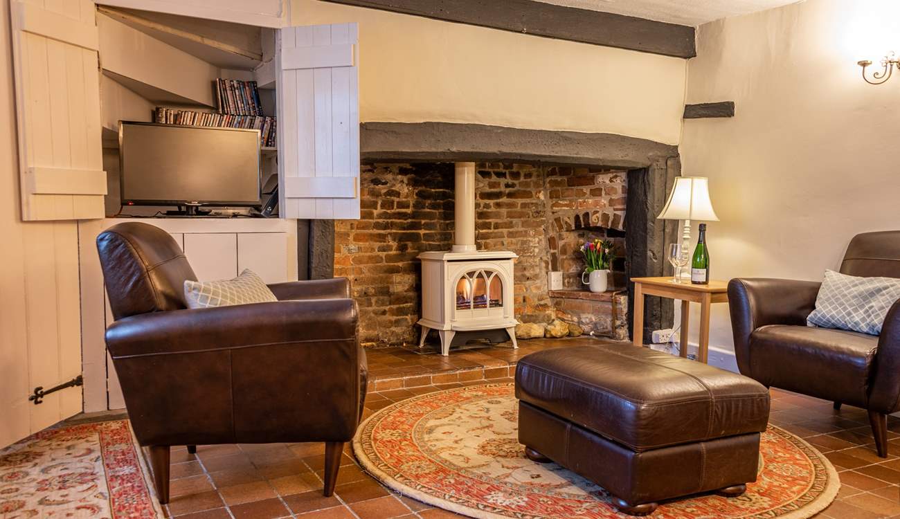 The television is cleverly hidden behind wooden doors.