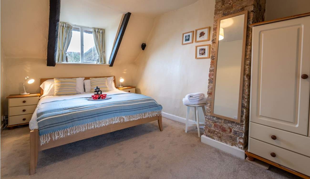 The master bedroom has a king-size double bed and lovely soft linens.