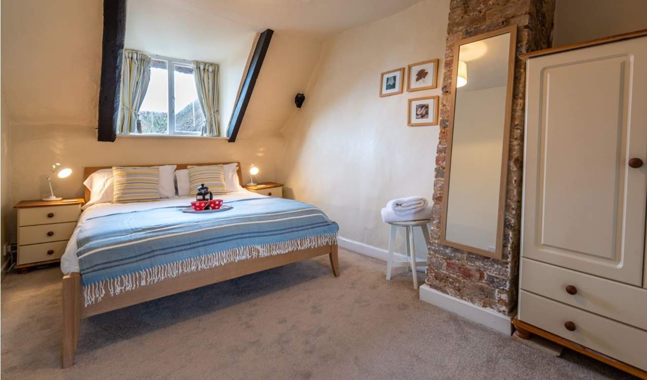 The master bedroom has a king-size double bed and lovely soft linens.