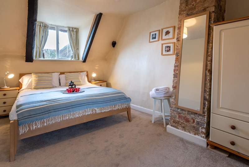 The master bedroom has a king-size double bed and lovely soft linens.