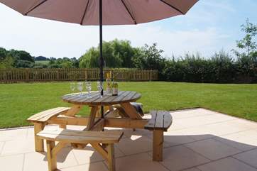 There is a really large patio and French windows from the sitting-room as well as a sliding door from the kitchen.