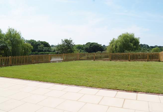 Another view of the garden. As well as the hot tub there is a barbecue, a picnic table and two sun loungers.