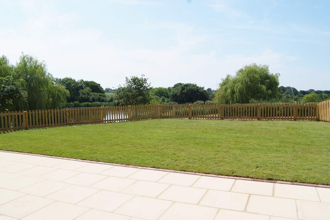 Another view of the garden. As well as the hot tub there is a barbecue, a picnic table and two sun loungers.