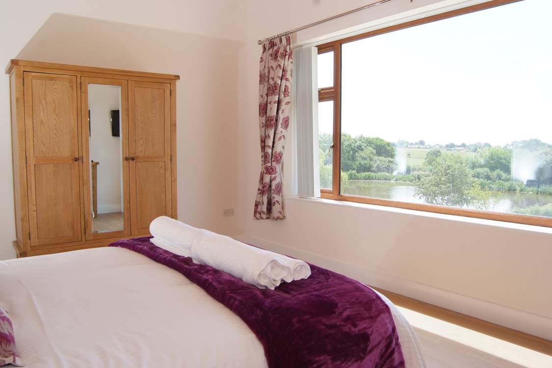 The master bedroom has a stunning panoramic view over the lakes and the countryside beyond.
