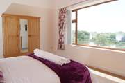 The master bedroom has a stunning panoramic view over the lakes and the countryside beyond.