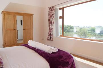 The master bedroom has a stunning panoramic view over the lakes and the countryside beyond.