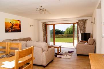 The living/dining room has French windows to the patio and garden and lovely country and lake views