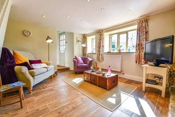 The comfy sitting-room with a small step up to the front door, bathroom and kitchen.