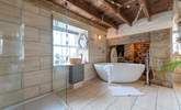 The luxurious bathroom with a free-standing bath and double shower. - Thumbnail Image