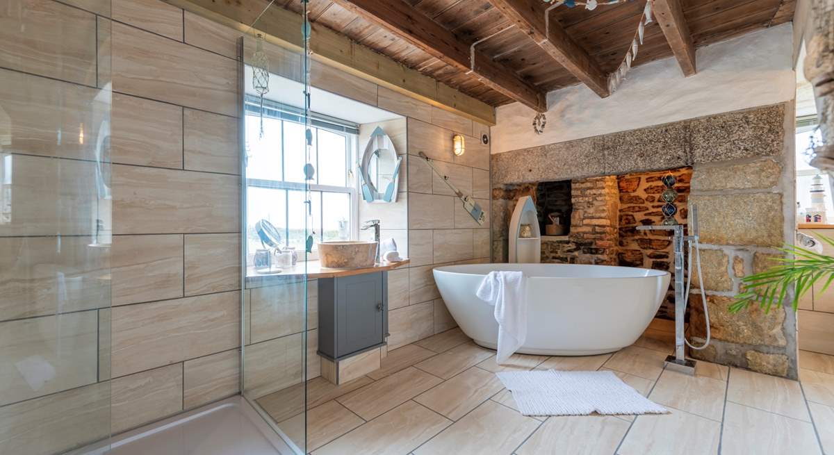 The luxurious bathroom with a free-standing bath and double shower.