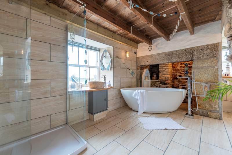 The luxurious bathroom with a free-standing bath and double shower.