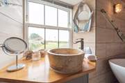 The bathroom has both modern and quirky fittings.