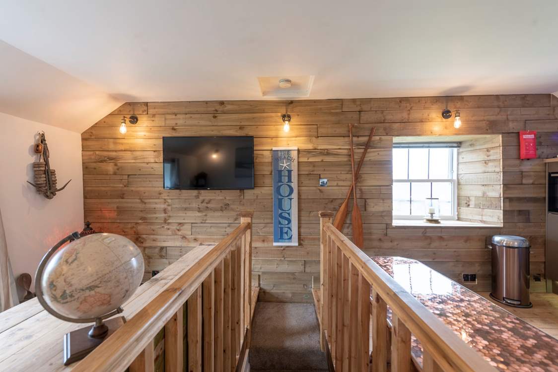 Up the stairs and to the left the sitting-area, and right the kitchen/dining area.