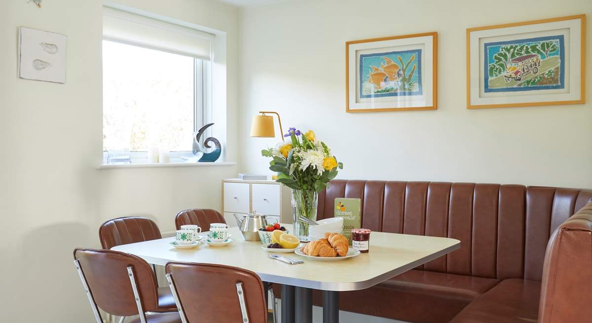 Plan your day ahead over a delicious breakfast in the dining area, designed with a retro feel and seating for eight.