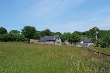 This is the view of the cottage from its own meadow with the historic farmhouse, used by the owners, in the background.