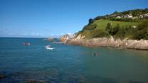 This is Combe Martin, with a lovely sandy bay - and in the distance the cliffs are where Exmoor meets the sea.