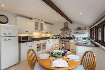 Three steps from the entrance hall take you up to a really lovely kitchen/dining-room with a stable-door to the front lawns.