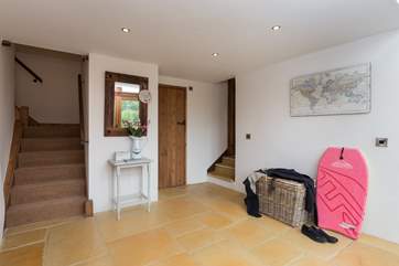 There is a really large entrance hall. The kitchen is off to the right and the sitting-room to the left.