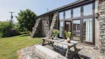 This detached barn conversion has a very private patio at the back, open gardens around it and a huge fenced meadow where guests, children and dogs are welcome to play and picnic.