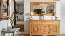 There is a really large entrance hall. The kitchen is off to the right and the sitting-room to the left.