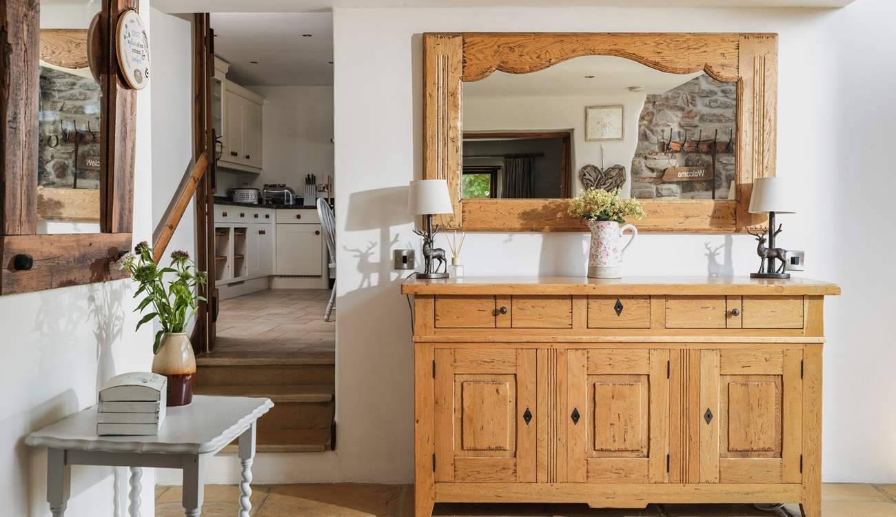 There is a really large entrance hall. The kitchen is off to the right and the sitting-room to the left.