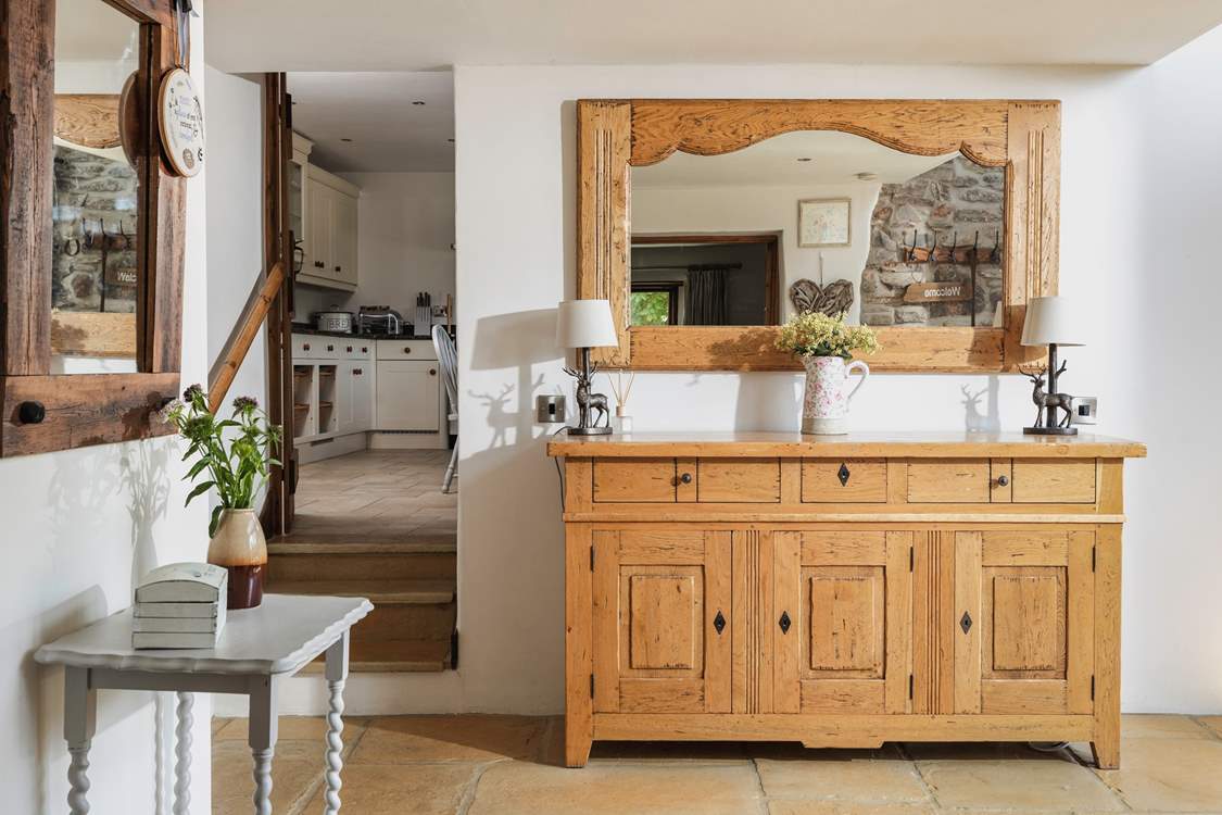 There is a really large entrance hall. The kitchen is off to the right and the sitting-room to the left.