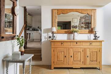 There is a really large entrance hall. The kitchen is off to the right and the sitting-room to the left.