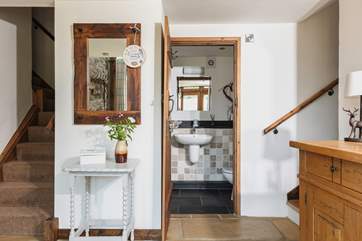 The downstairs WC next to this step up into the kitchen diner.