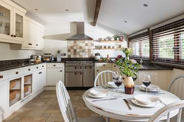 Three steps from the entrance hall take you up to a really lovely kitchen/dining-room with a stable-door to the front lawns.