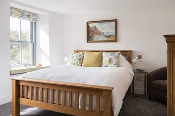 One step down takes you into the calm main bedroom (Bedroom 1).