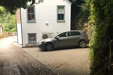 The parking space next to the house for two medium cars can be parked in parallel to the road or to the house.