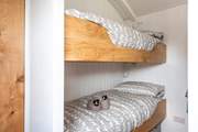 The cute bunk-beds are cleverly tucked behind a wall behind the king-size double bed.
