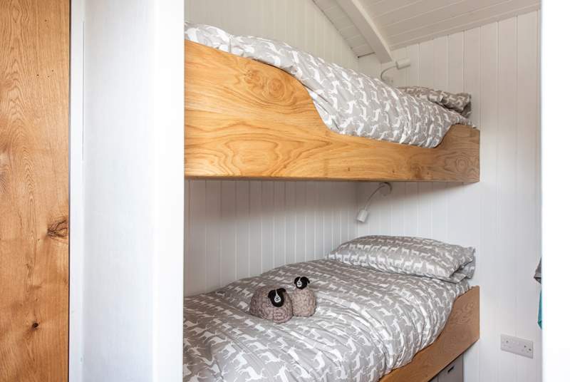 The cute bunk-beds are cleverly tucked behind a wall behind the king-size double bed.