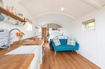 The beautiful living-area is open plan, light and airy, with everything you could need for a comfortable stay.