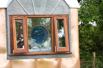 The gorgeous stain glass porthole windows depict the phasing of the moon.
