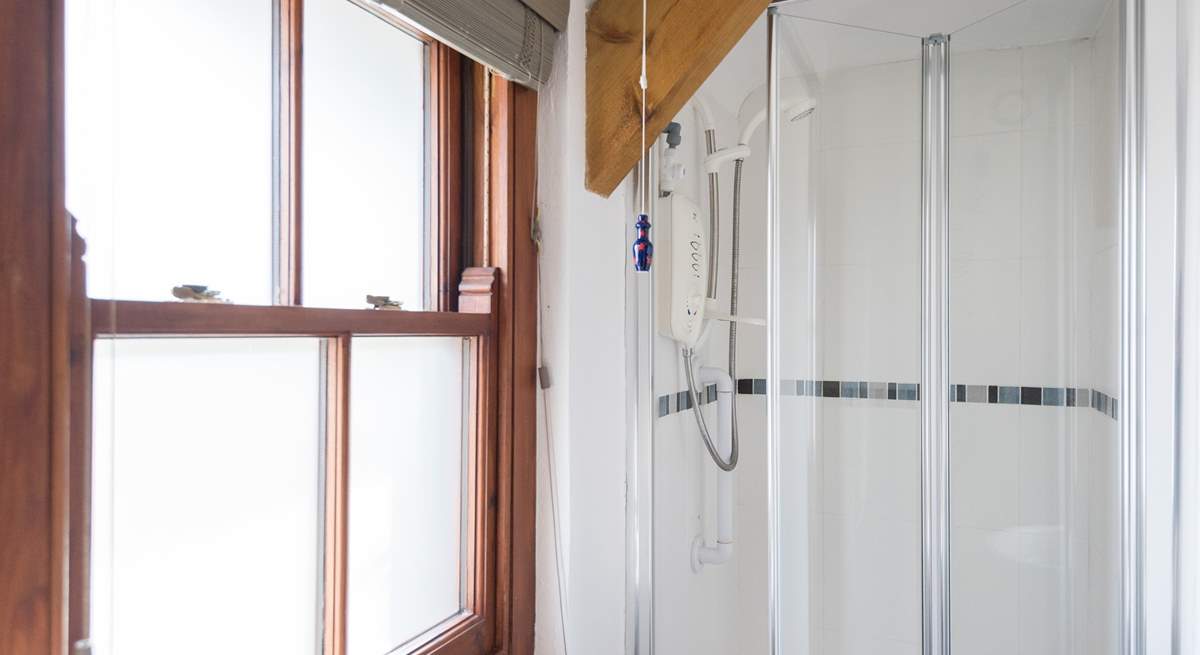 The en suite shower-room, with a small step leading into the shower (approx. 13 inches).