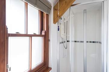 The en suite shower-room, with a small step leading into the shower (approx. 13 inches).