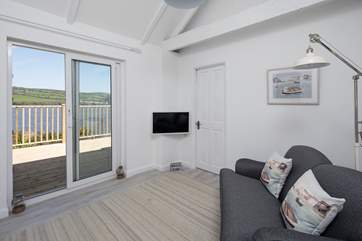 The annexe sitting-room leads nicely onto the decking and offers the most splendid views from the comfort of the attractive sofa.