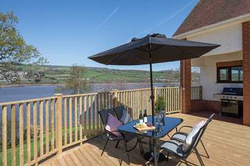 This immense decked-area is kitted out with a huge gas barbecue, bubbling hot tub, and several seating-areas. Perfect for watching the children play on the lawn below.