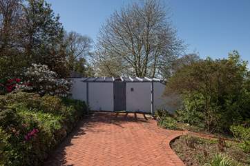 Behind this attractive wall lies another expanse of lawn. Your four-legged friends are going to be in holiday heaven.