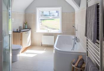 Family bathroom with shower cubicle and bath with shower attachment.