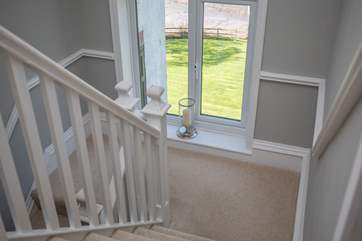 The 2-tiered staircase wind up to the first floor, offering wonderful views on the way.