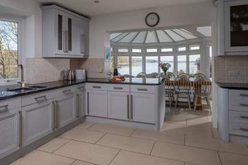 The kitchen leads into the dining-area where a huge dining-table, with the most delightful views await.