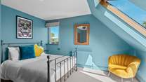 Bedroom 5 has a king-size bed and a view from the Velux window towards the estuary.