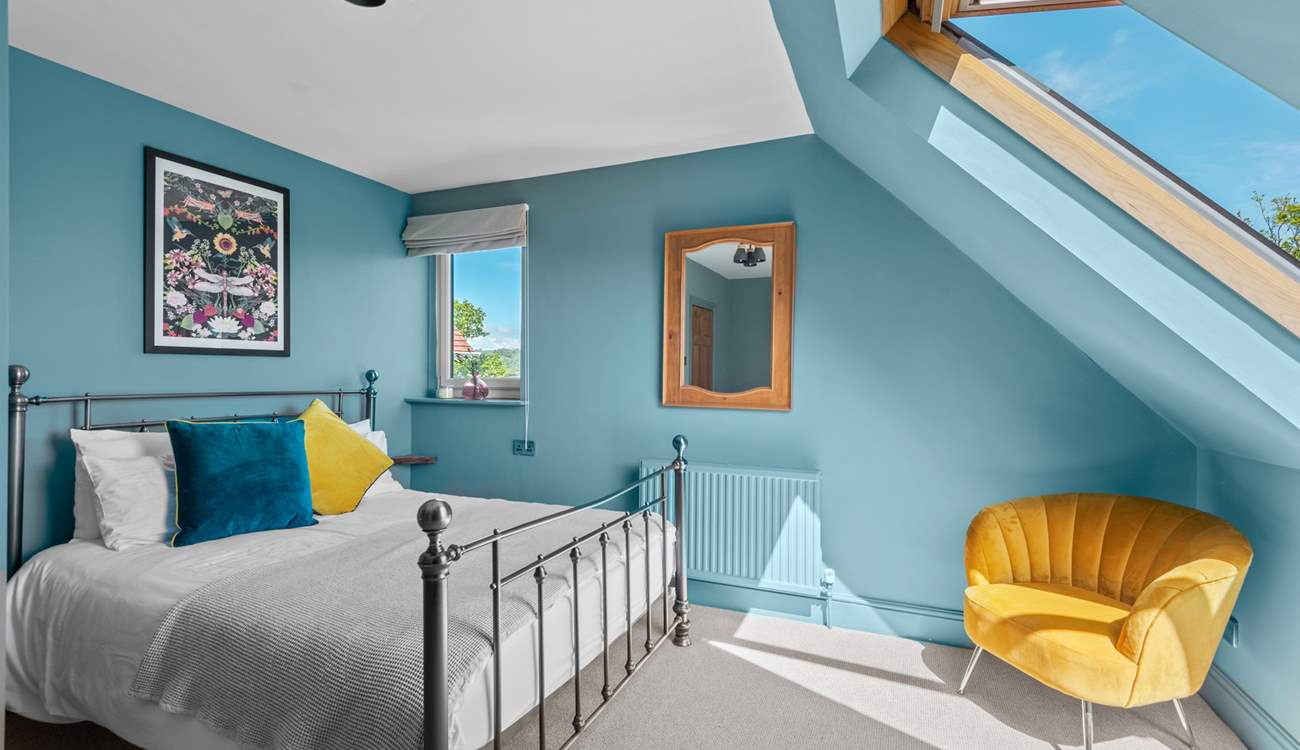 Bedroom 5 has a king-size bed and a view from the Velux window towards the estuary.